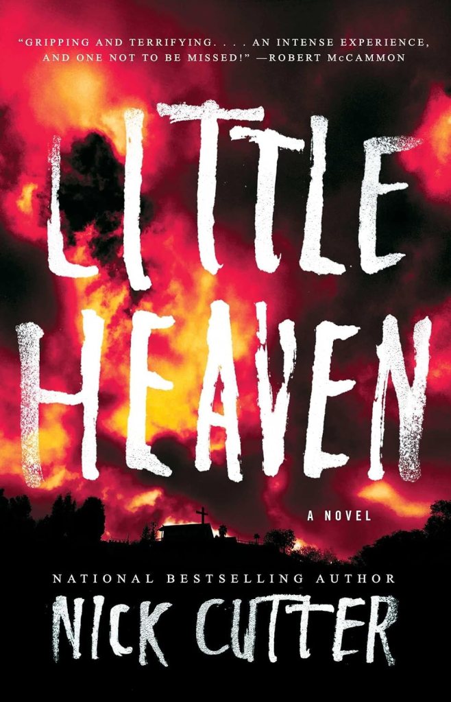 Book cover of 'Little Heaven' by Nick Cutter featuring a dramatic red and orange sky with silhouettes of trees and a cross in the foreground, along with a prominent title and author name.