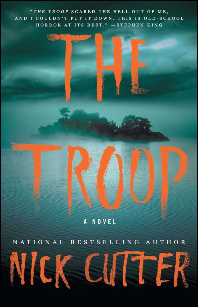 Cover of the novel 'The Troop' by Nick Cutter, featuring a dark background with a lake and an island, with the title in bold orange letters.